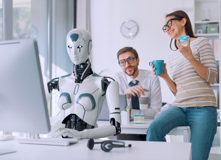 As image of an efficient AI robot working in the office and lazy employees having a coffee break