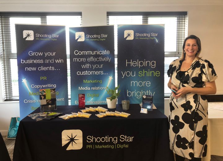 Emma on Shooting Star branded stand at conference